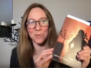 Laura holding a copy of her book